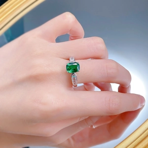 Detail of S925 silver ring featuring a rectangular green stone and side diamonds
