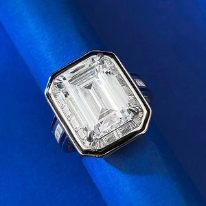 Macro shot of 10*14 emerald-cut solitaire ring with tapered baguette side stones