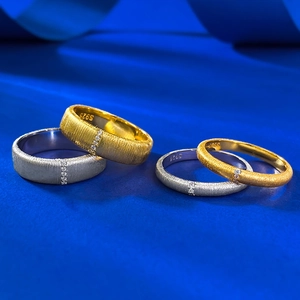 Macro shot of brushed S925 silver rings with micro-set diamonds on blue texture