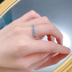 Detail of S925 silver ring featuring blue Paraiba stones and micro-pave white zircon rows