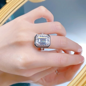 Macro view of Asscher cut high carbon diamond ring with halo setting on a finger