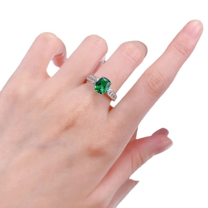 S925 silver ring featuring emerald cut green gemstone with tapered side stones