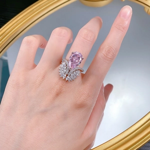 Close-up of S925 silver ring with pear-cut pink diamond and marquise side stones