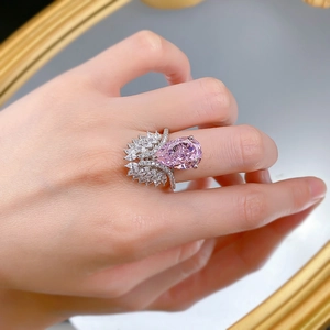 Macro detail of S925 silver ring featuring a pear-cut pink stone with marquise white gems