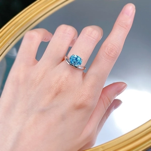 Close-up of S925 silver ring with 8x10mm oval aquamarine blue carbon diamond on finger