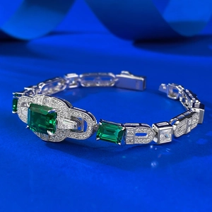 Detailed macro view of the square emerald cut green gemstone with sparkling zircon halo