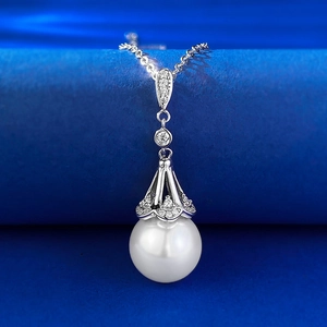 Detailed macro of S925 silver necklace featuring a 12mm white shell pearl and crystal pendant