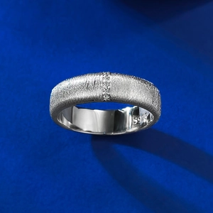 Detail of S925 sterling silver wide ring featuring a brushed finish and vertical pavé diamonds