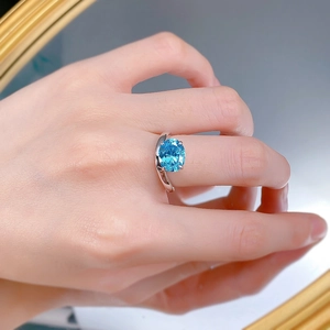 Close-up of S925 silver ring with 8x10mm oval aquamarine carbon diamond on finger