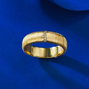 Macro view of wide gold plated S925 silver ring with brushed texture and zircon inlay