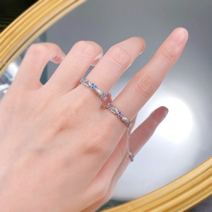 Detailed shot of stacked S925 silver heart rings with blue and purple zircon gemstones
