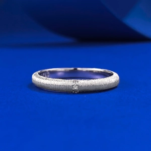 Minimalist S925 sterling silver brushed ring with center zircon on blue background