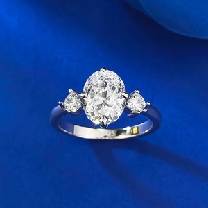 Detail showing the S925 hallmark on an oval cut three-stone silver engagement ring