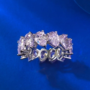 Macro shot of S925 silver ring with pear-cut pink gems in a full pavé setting