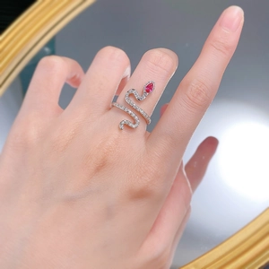 Detailed view of an S925 silver snake ring with a pear-cut red gemstone on a finger