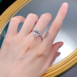 Macro detail of oval cut white gemstone on silver bamboo textured ring band