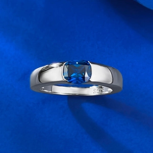 Detailed close-up of S925 sterling silver stamp and square blue gemstone on ring