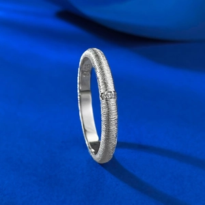 Macro view of S925 sterling silver brushed ring featuring three inset white zircons