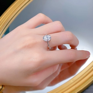 Close-up of S925 silver ring featuring an oval diamond and bamboo-style band on finger