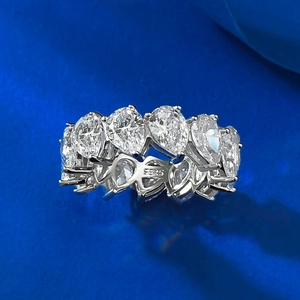 Macro shot of S925 silver eternity band with pear-cut cubic zirconia in soft lighting