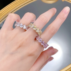 Three S925 silver pear-cut diamond rings in white, yellow, and pink colors on hand