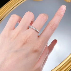 Detailed view of S925 sterling silver ring with brushed texture on a person hand
