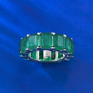 Macro shot of S925 sterling silver stamp on emerald cut green gemstone eternity ring