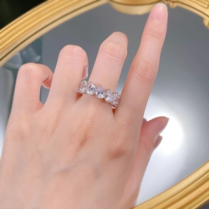 Close-up of S925 silver ring featuring a row of sparkling pear-cut diamonds on finger