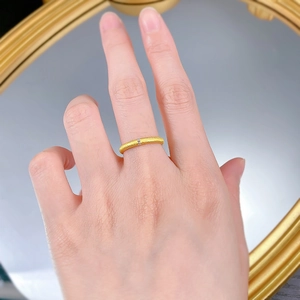 Detailed macro view of S925 sterling silver brushed gold ring with three inset gemstones