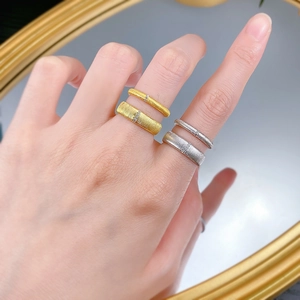 Close-up of S925 sterling silver brushed rings in gold and silver set with small zircons