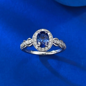 Detailed view of an oval blue sapphire ring in an S925 silver halo setting