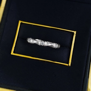 Macro shot of silver bamboo joint ring with sparkling zircon stones in a velvet box