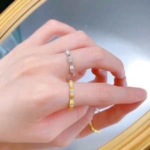 Detail of S925 silver bamboo rings with brushed texture and zircon stones on hand