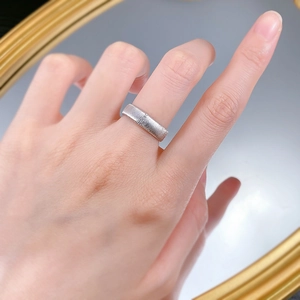 Close-up of wide brushed S925 sterling silver ring showing matte metallic texture