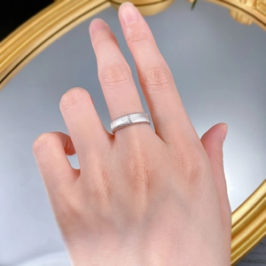 Close-up of brushed S925 sterling silver wide ring with vertical textured finish