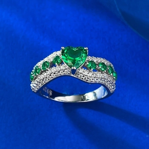 Macro shot of S925 sterling silver stamp and heart-shaped green emerald stone ring