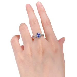 Classic oval blue sapphire ring with white zircon halo and intricate woven silver band