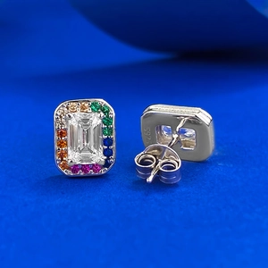 Macro shot of S925 silver stud earrings with rainbow zircon and emerald-cut white stone