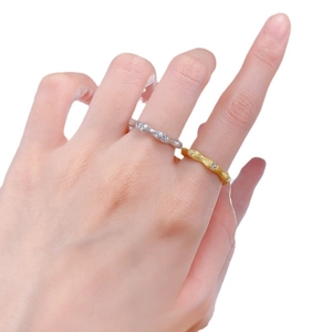 Bamboo style S925 silver and gold rings with sparkling stones on model's hand
