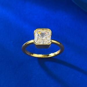 Detailed shot of S925 engraved gold bezel ring with square radiant cut white stone