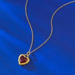 S925 silver gold-plated garnet heart pendant necklace with brushed finish on blue background