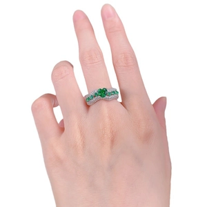 Luxurious wide heart-shaped green emerald ring with white diamond pavé setting