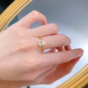 Macro detail of radiant cut square white diamond ring on elegant gold minimalist band