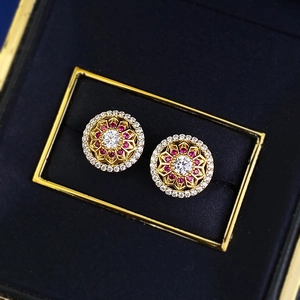 Elegant S925 gilded flower studs with white stones and rubies in a navy jewelry box