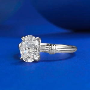 Elegant S925 silver oval-cut solitaire ring with textured band on blue background