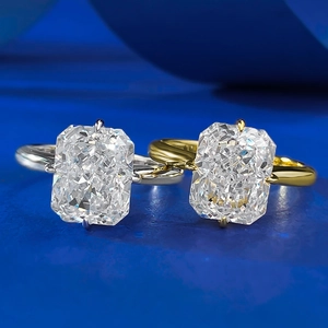 Macro shot of rectangular radiant cut stones in silver and gold four-prong settings