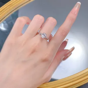 Macro shot of S925 silver gold-plated ring with oval clear stone on model finger