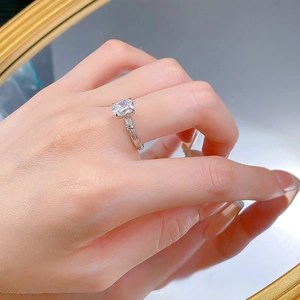 Detailed close-up of oval cut gemstone ring with textured band in S925 sterling silver