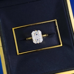 Macro shot of rectangular radiant cut diamond ring in a premium blue velvet jewelry box