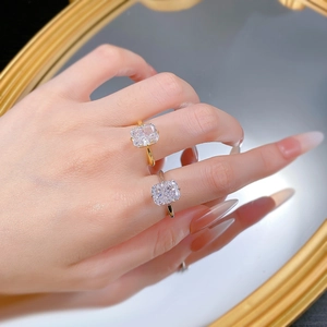 Close-up of dual-tone S925 silver and gold rings featuring radiant cut carbon diamonds